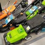 Modern petrol and electric lawn mowers in a building materials hypermarket