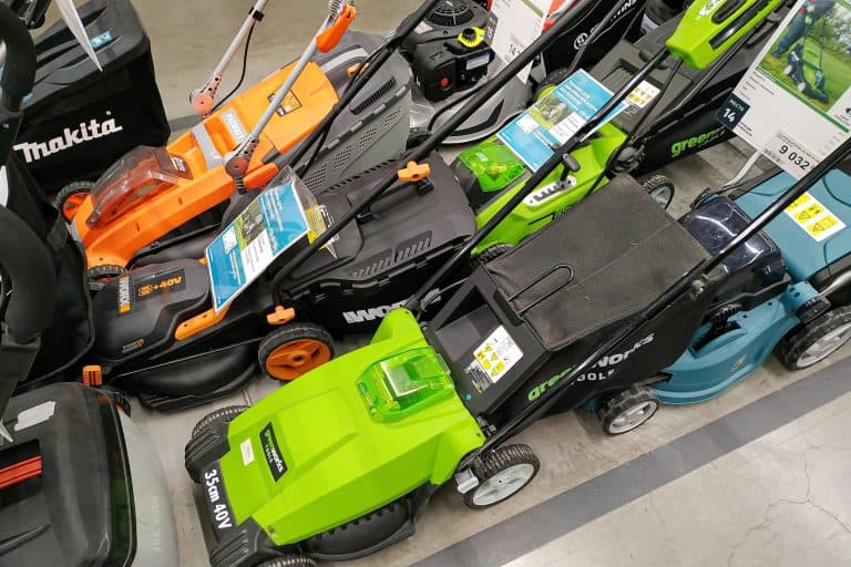 Modern petrol and electric lawn mowers in a building materials hypermarket